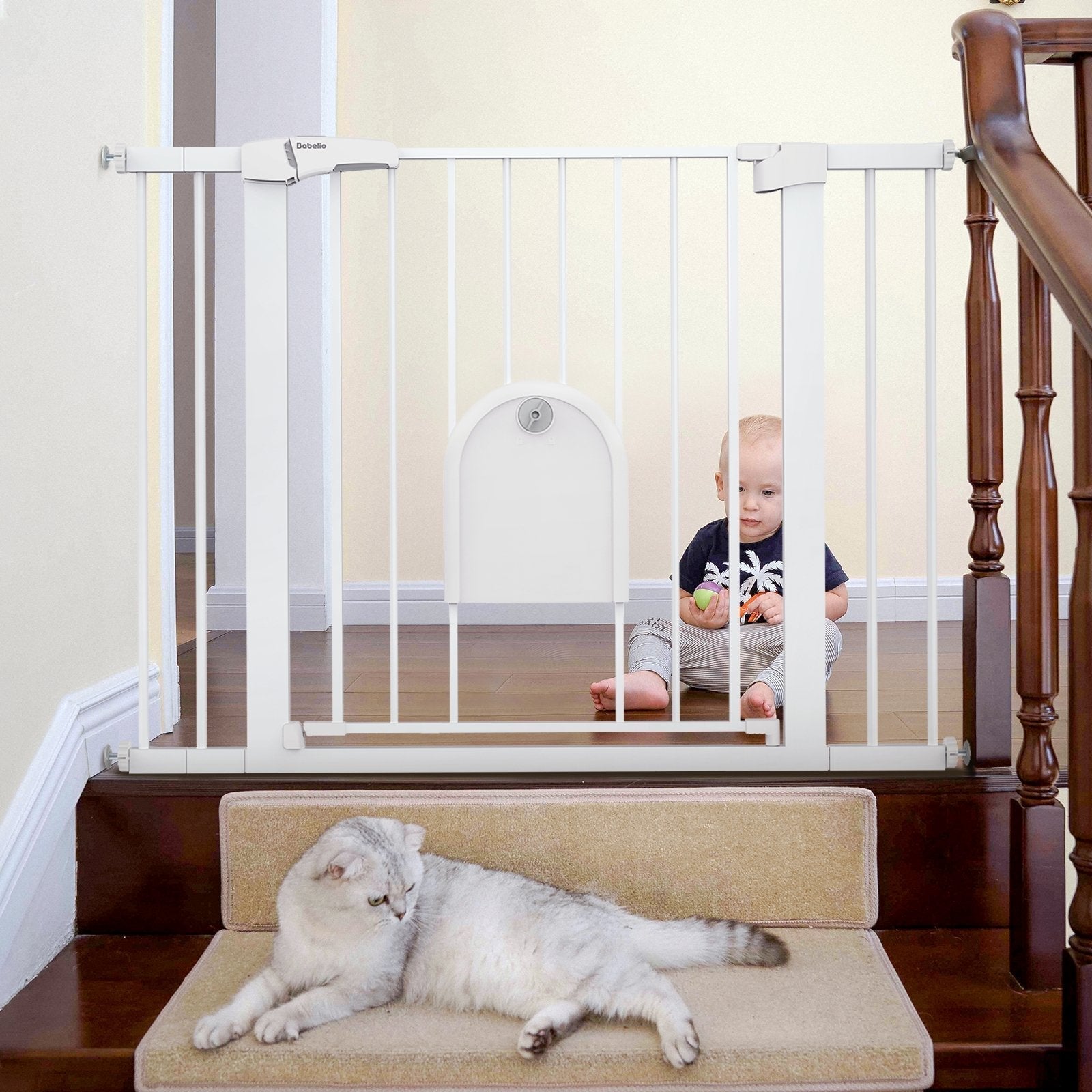 Babelio baby safety gate installed by stairs with baby in hallway and cat on steps
