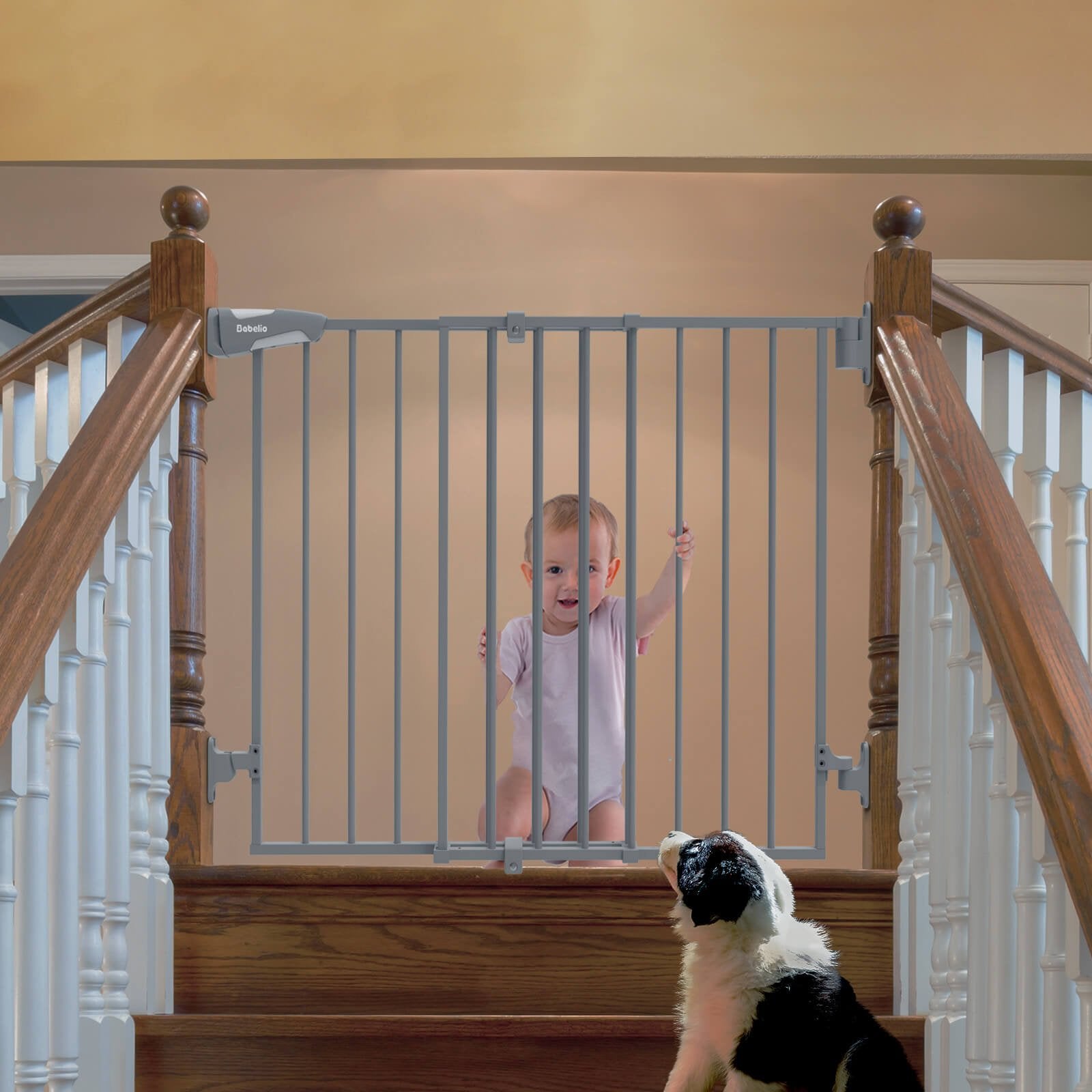 Babelio baby safety gate installed on staircase, with baby and dog in hallway setting