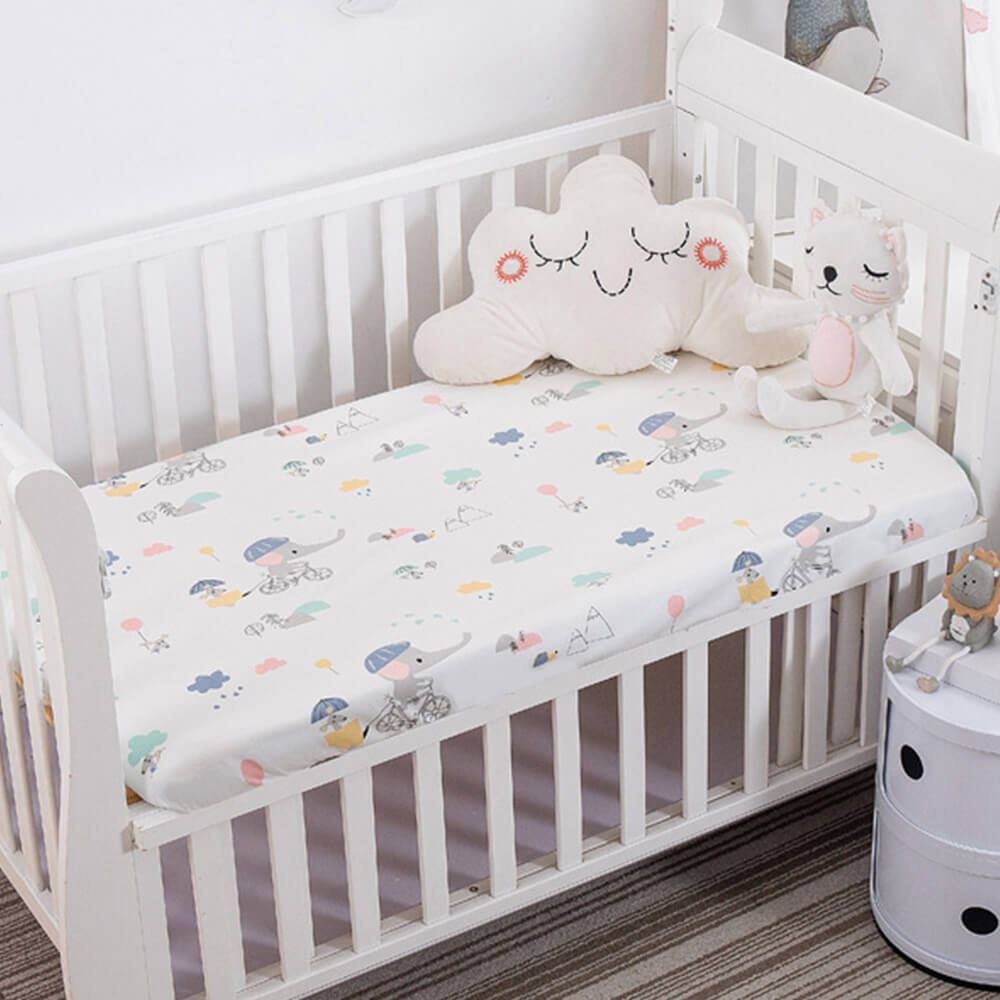 Babelio crib mattress in a nursery with playful bedding and plush toys