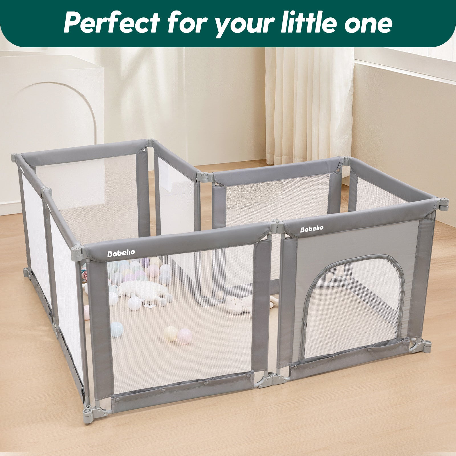 Gray baby playpen with transparent mesh doors on a wooden floor, with toys scattered around.