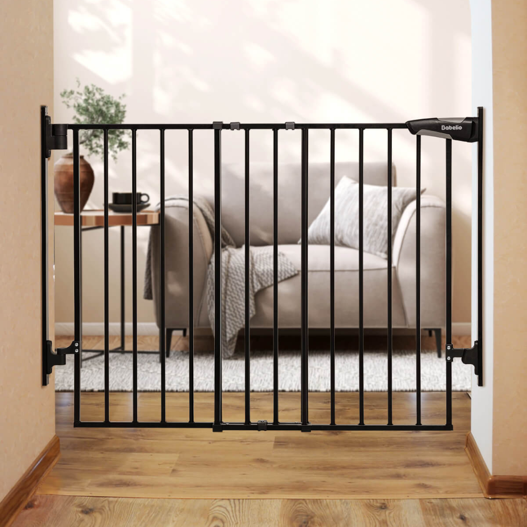 Adjustable baby gate installed at the top of a staircase with a metal frame and a walk-through design.
