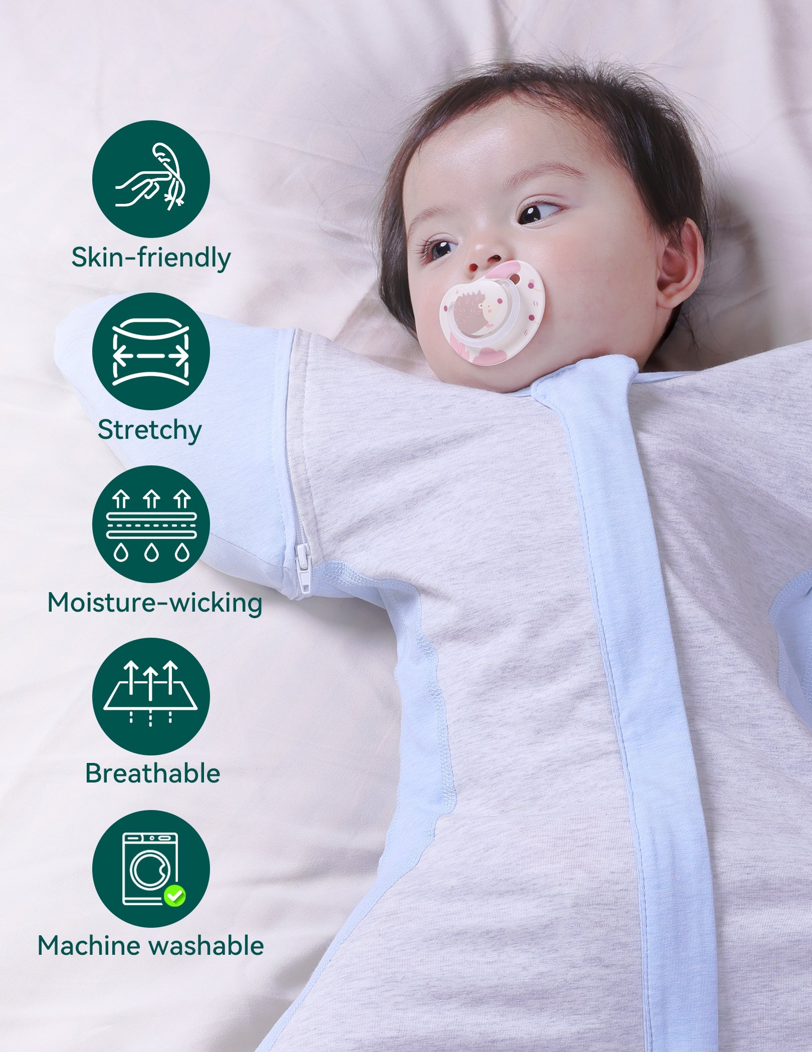 Babelio baby in light blue swaddle with detachable sleeves on a bed, nursery setting