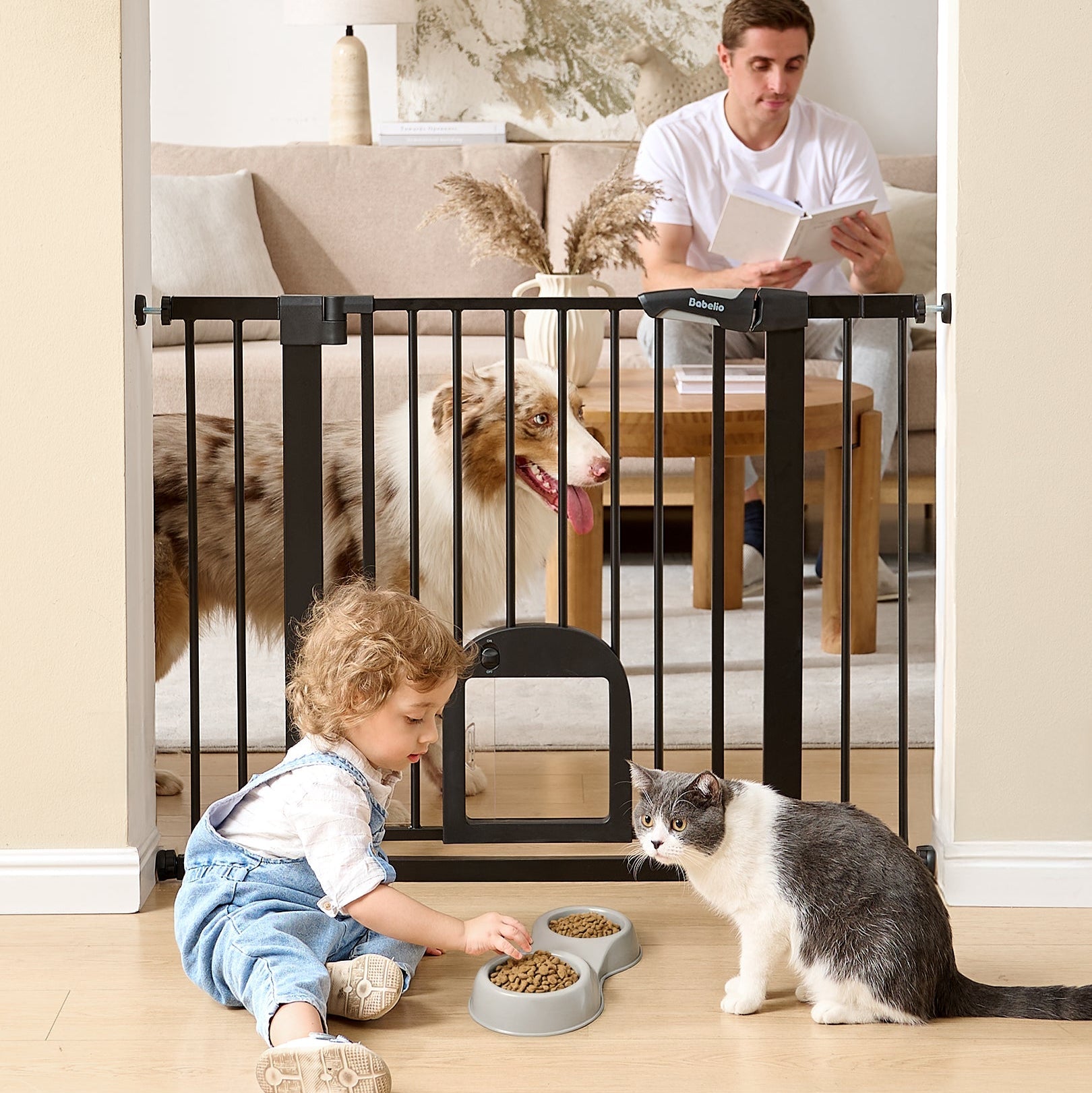 Babelio baby safety gate with cat door separating living room, toddler and cat in foreground