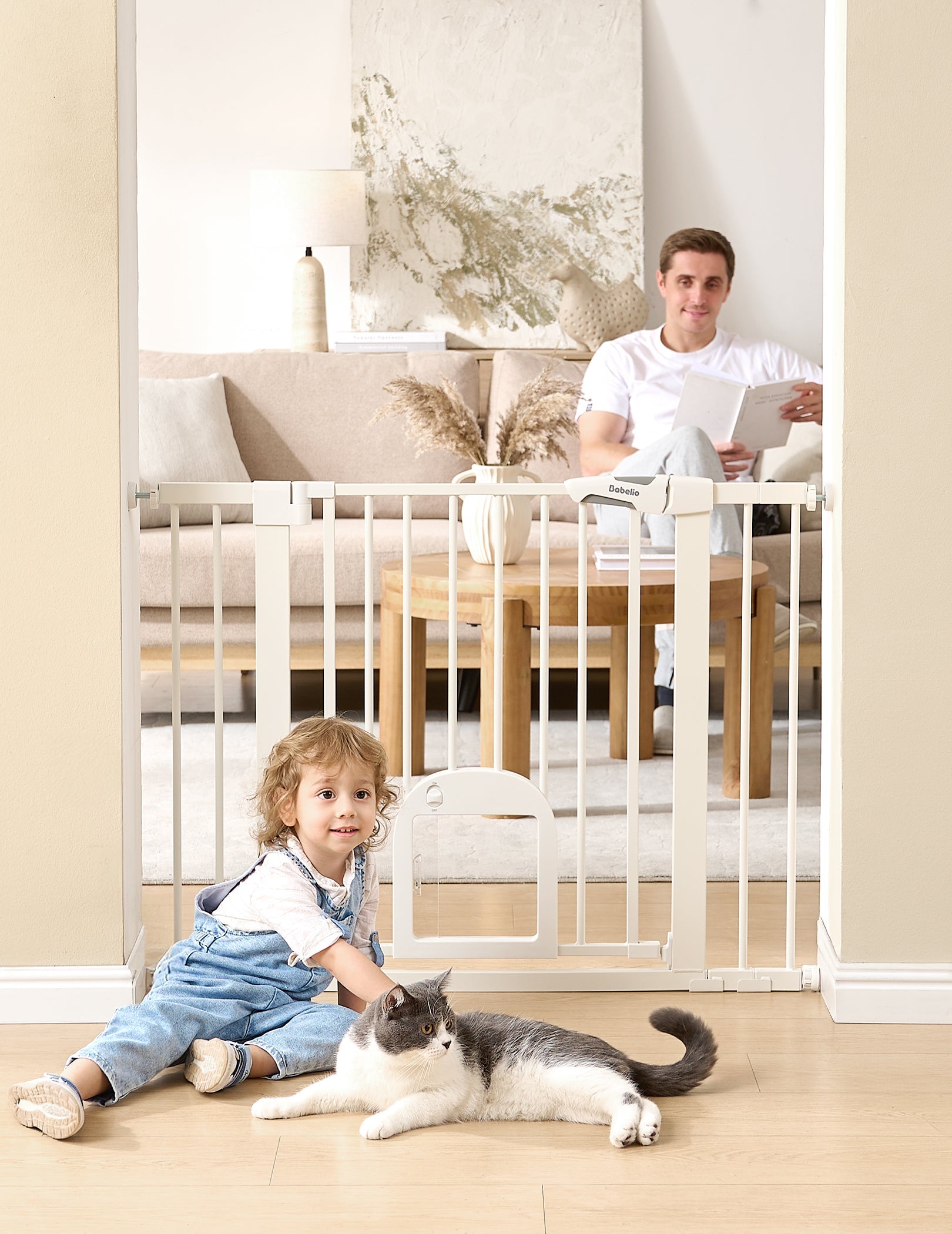 Babelio baby safety gate with cat door in a living room, child and cat on floor, adult seated