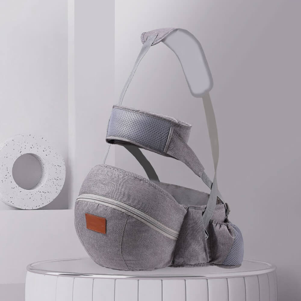 Babelio gray baby waist stool and infant carrier on display in a modern room setting