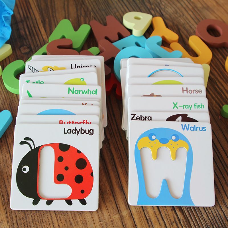 Babelio animal alphabet flash cards on a wooden table, perfect for nursery learning.