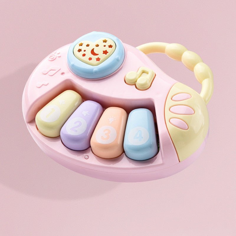 Babelio pastel baby musical toy piano with handle on pink background