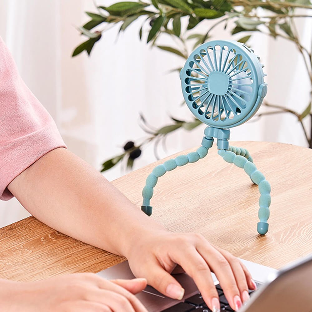 Babelio portable mini fan with bendable stand on desk near laptop in home office setting