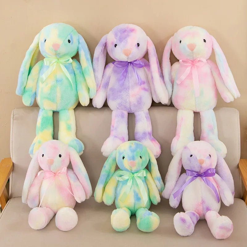 Babelio pastel bunny plush toys with ribbons arranged on a nursery sofa