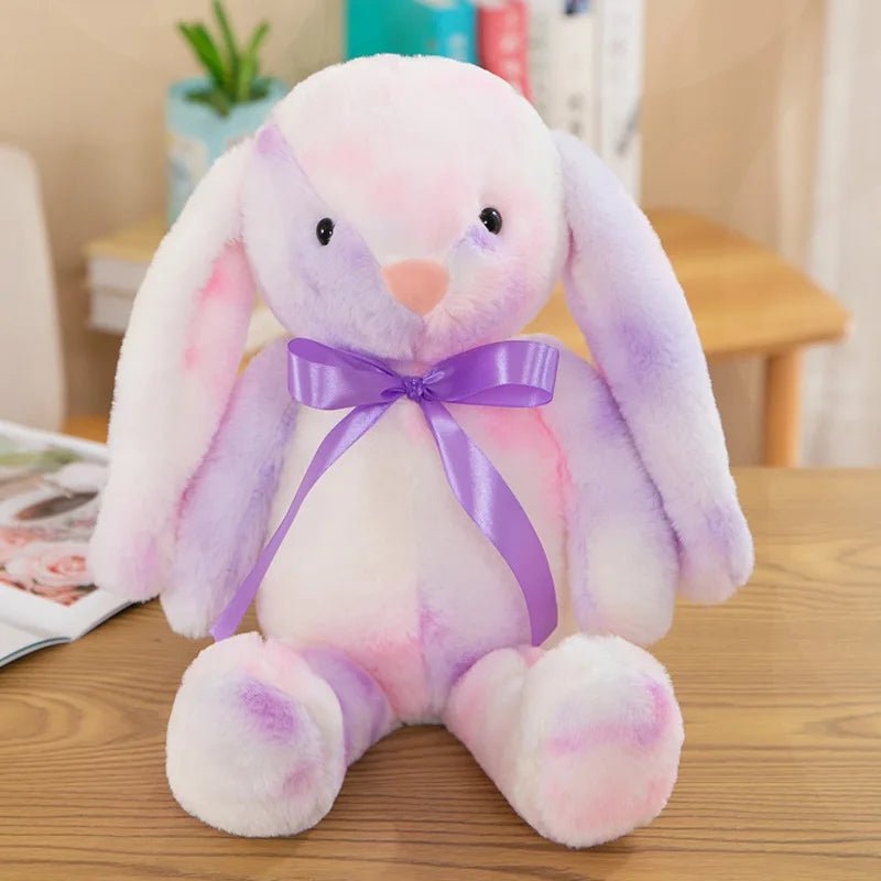Babelio pastel plush bunny toy with purple ribbon on table in nursery setting