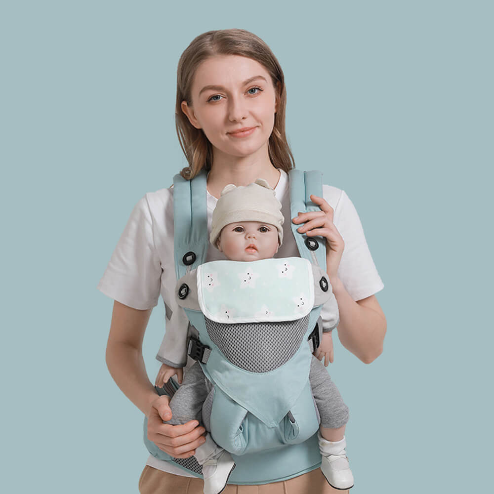 Babelio ergonomic baby carrier with hip seat worn by a woman and baby in a studio setting