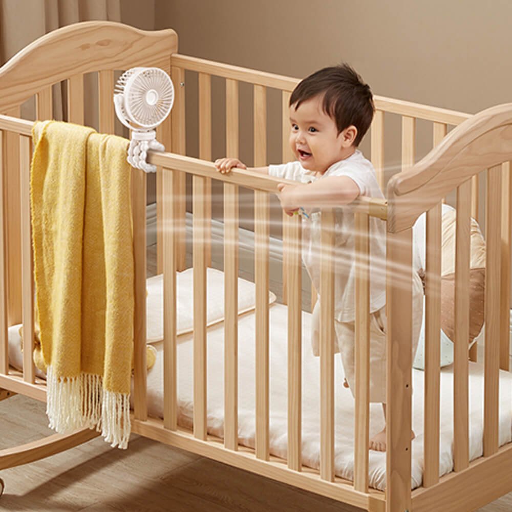 Babelio mini USB octopus fan with flexible legs attached to baby crib in nursery
