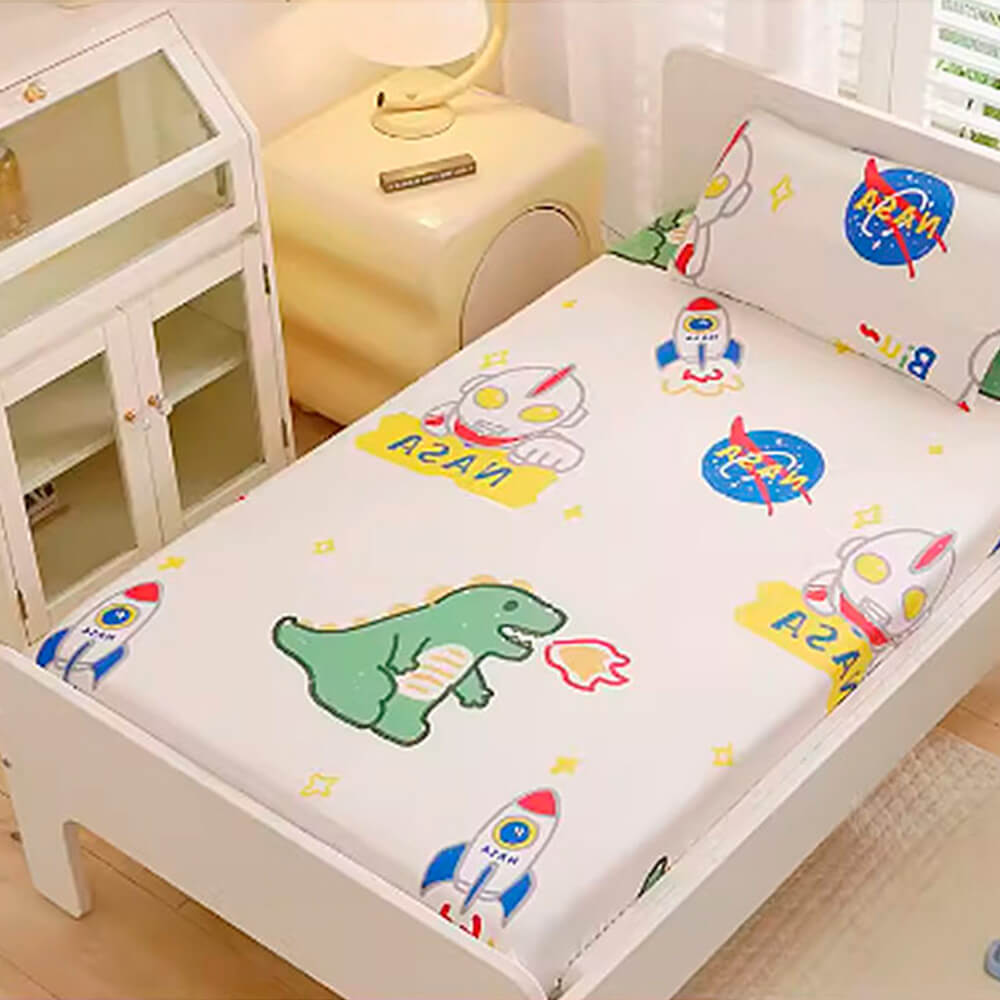 Babelio crib mattress in a nursery with playful cartoon dinosaurs and rockets pattern