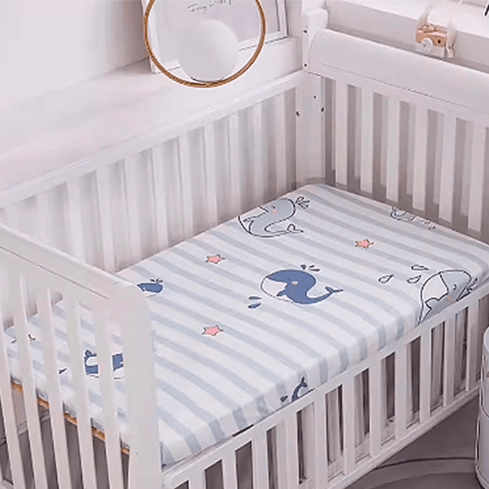 Babelio crib mattress with playful whale cartoon pattern in a nursery