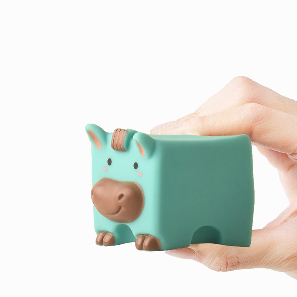 Hand holding a cute teal Babelio baby animal toy, perfect for nursery playtime