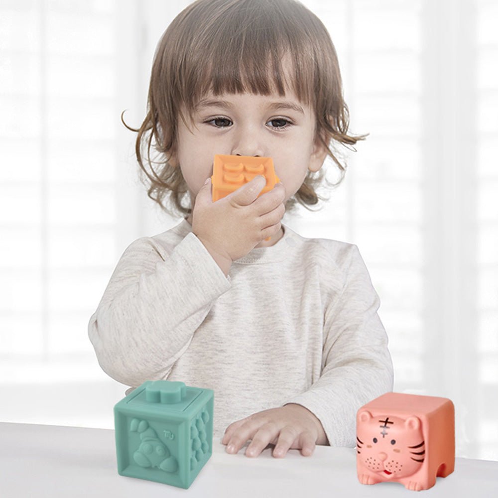 Baby playing with colorful Babelio sensory blocks in a nursery setting
