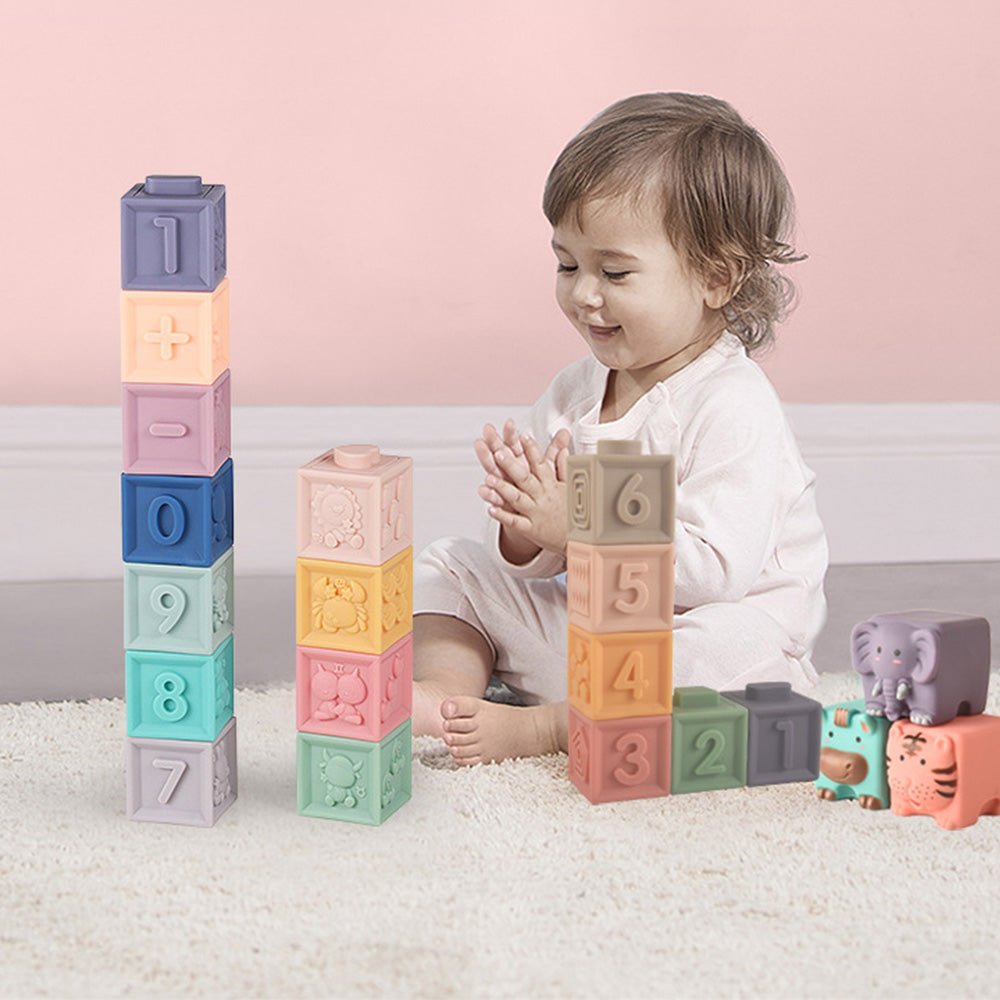 Baby playing with colorful stacking blocks on carpet in nursery, Babelio