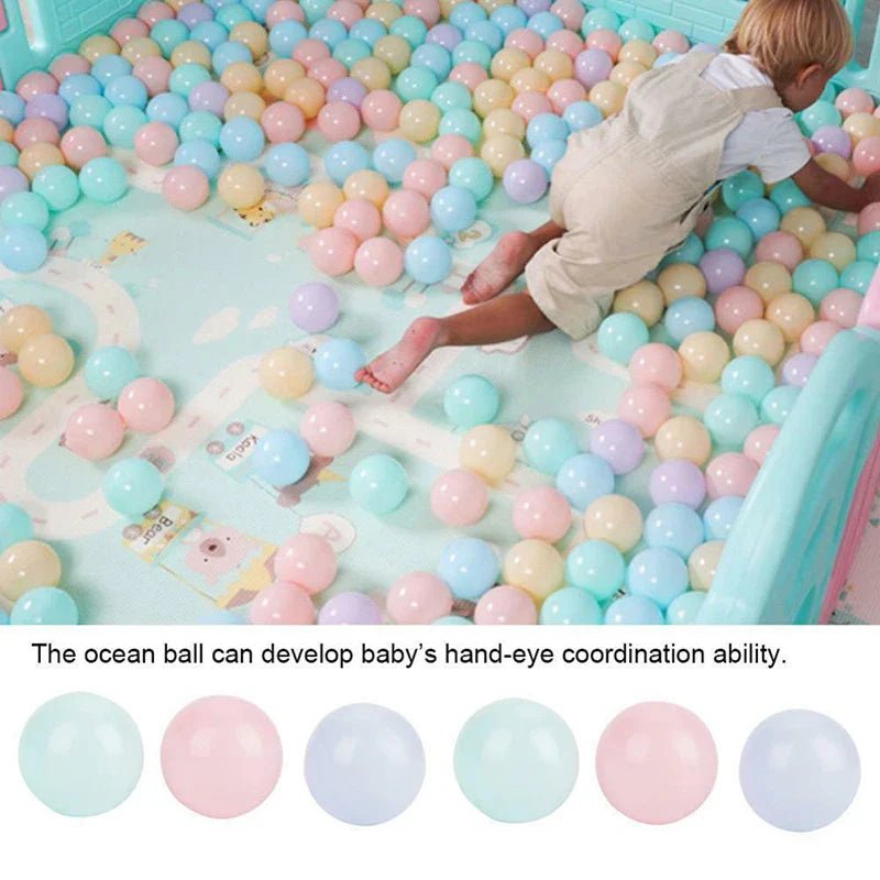 Babelio pastel playpen balls and baby playing in a nursery enclosed by a baby safety gate