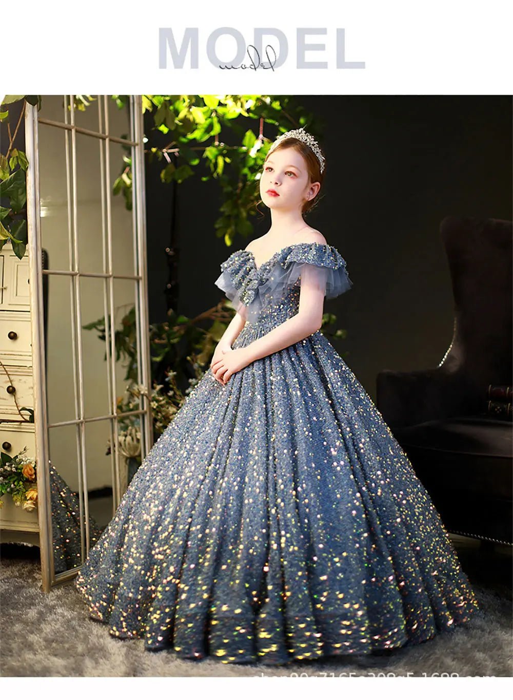 Young girl in a sparkly blue sequin ball gown with tiara, standing in elegant room, Babelio