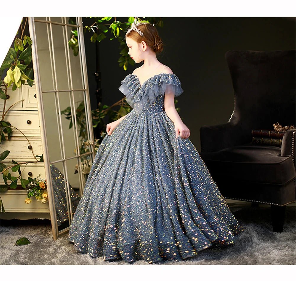Babelio elegant sequin ball gown for little girls, modeled in a stylish living room setting.