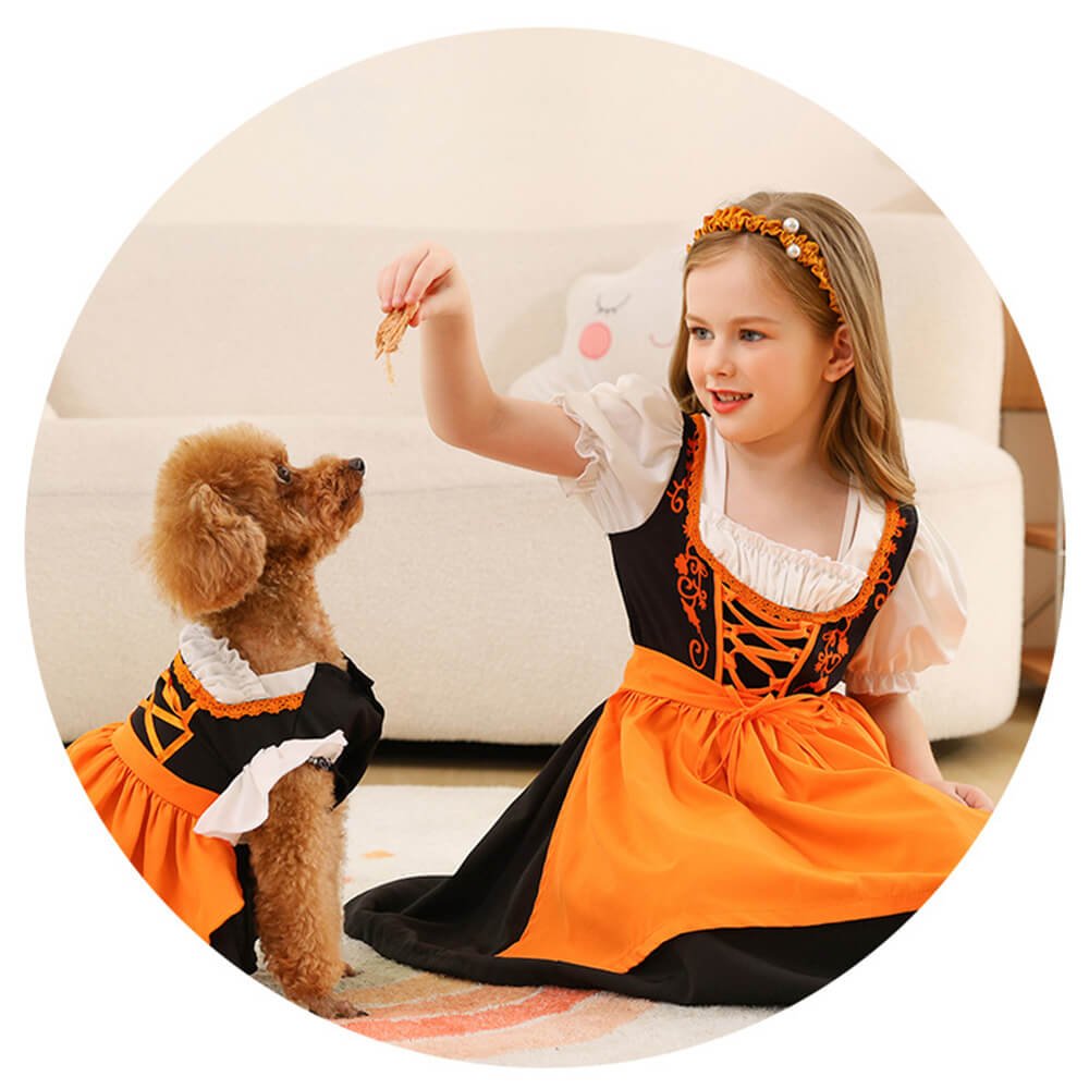 Babelio girl and dog in matching orange costumes sitting in a living room