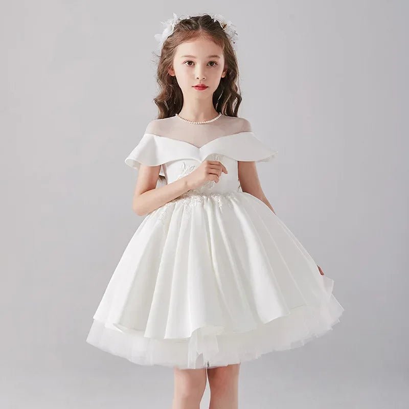Babelio flower girl in elegant white formal dress, studio backdrop