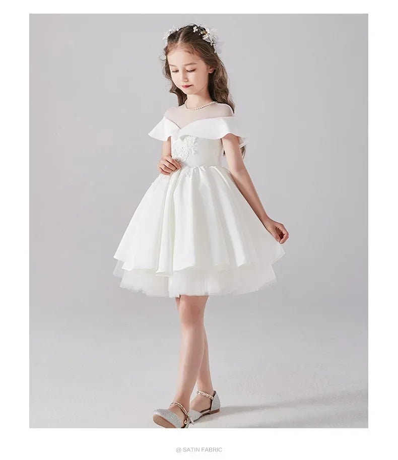 Babelio elegant white flower girl dress for formal occasion, modeled in studio setting