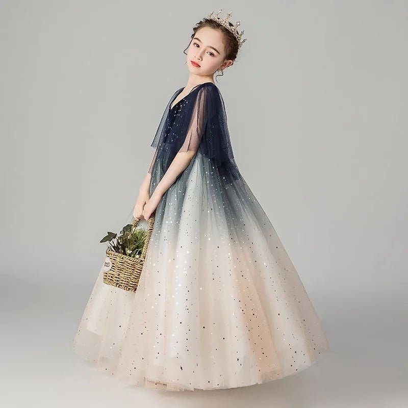 Babelio girl wearing a sequin princess dress and crown, holding a basket in a studio setting