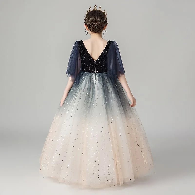 Babelio girl wearing a princess sequin dress with tulle skirt and crown in studio setting