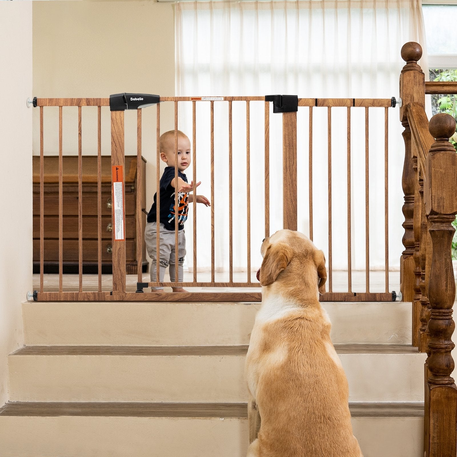 Babelio wood-pattern baby safety gate at top of stairs in living room with toddler and dog