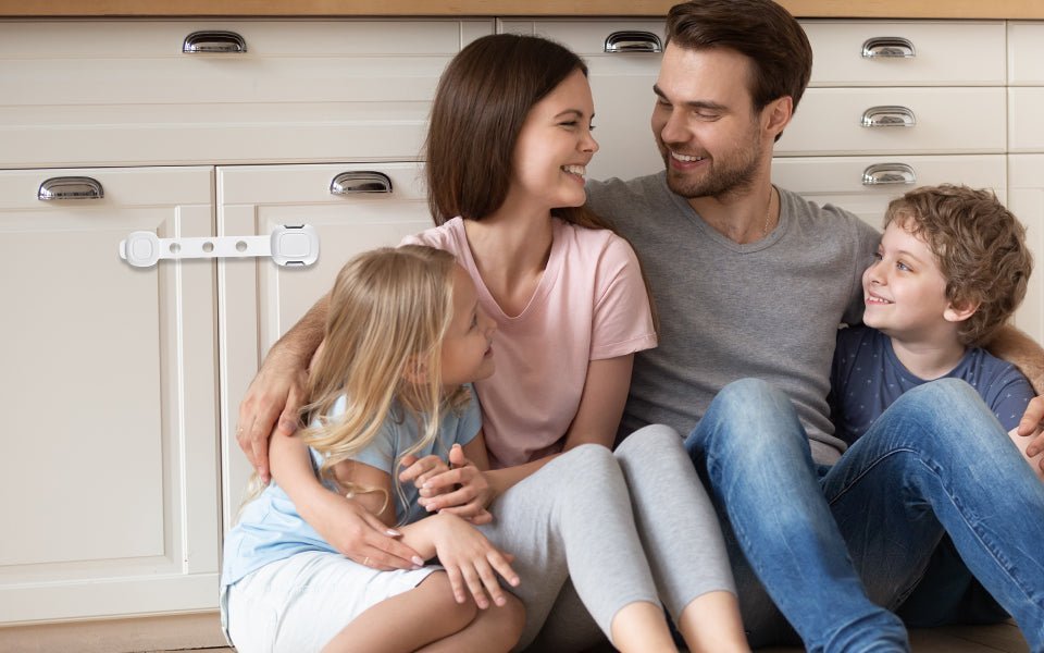Family with young children sitting in kitchen by baby safety cabinet lock from Babelio