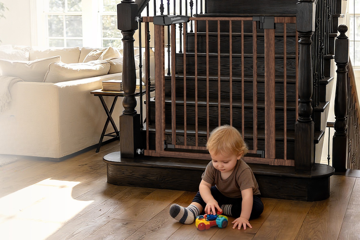 Babelio baby safety gate installed at staircase in living room with child playing nearby