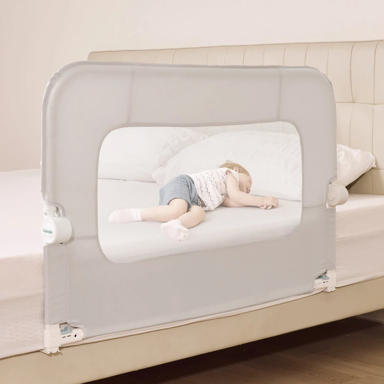Babelio baby safety gate on a bed in a bedroom, with a toddler sleeping safely inside