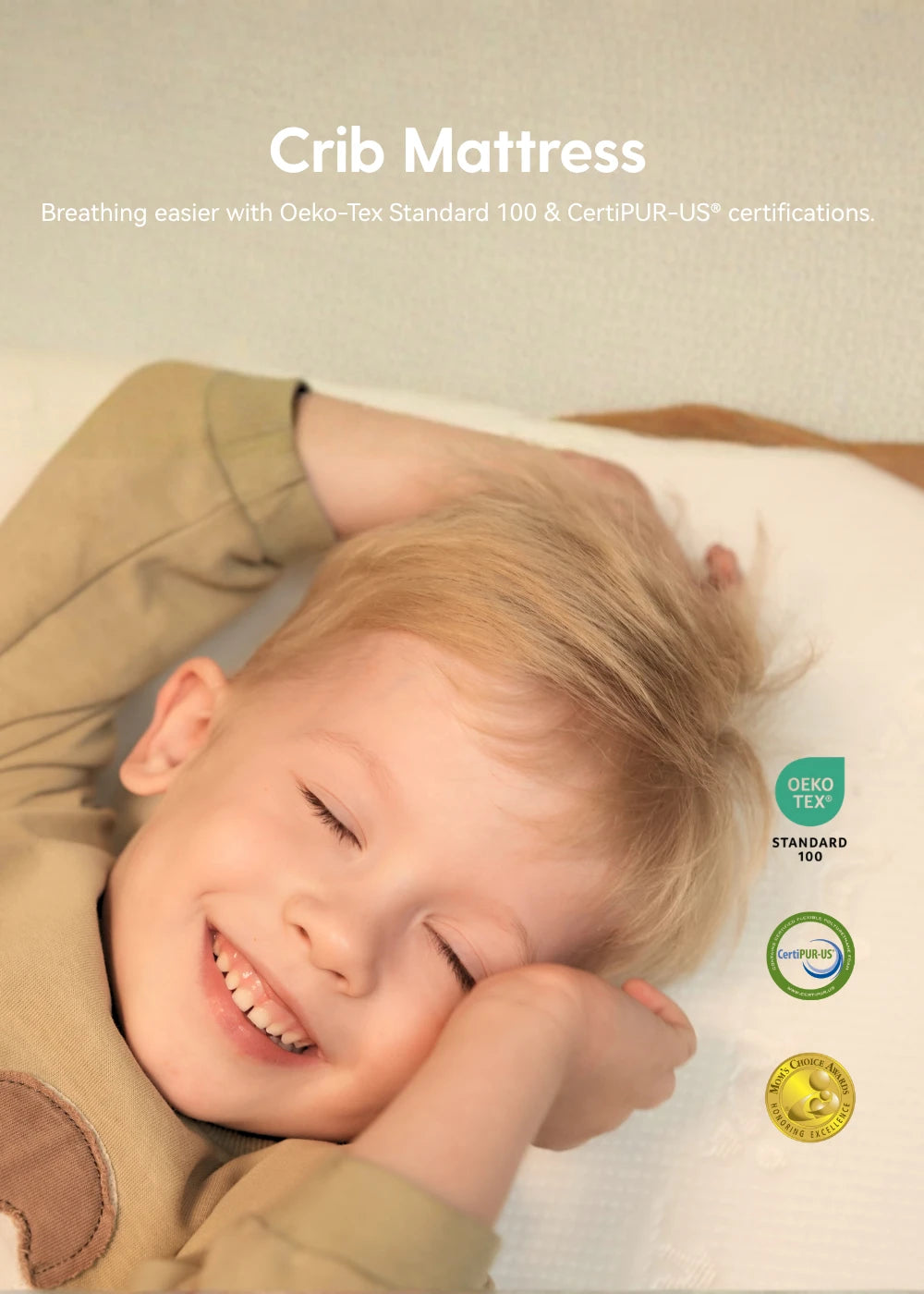 Child lying on a crib mattress with certification logos displayed.
