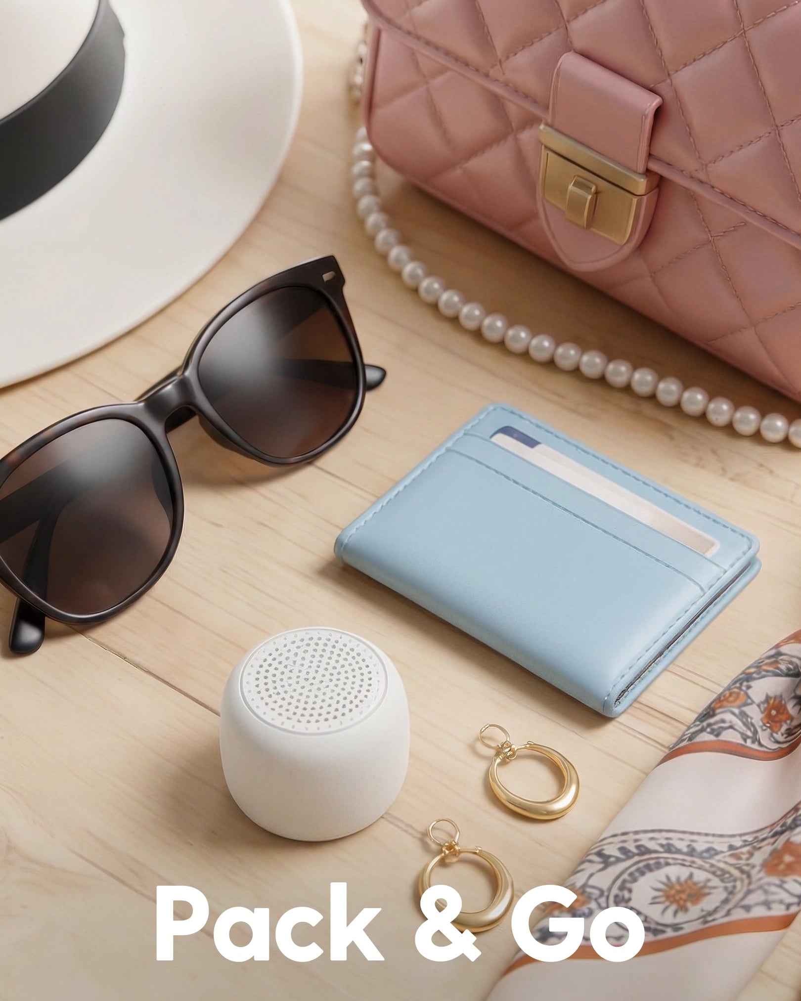 Babelio portable white noise machine on tabletop with purse, sunglasses, and travel accessories