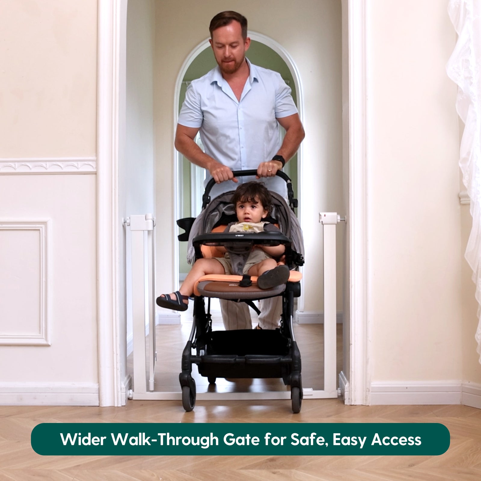 Man pushing a stroller with a child through a doorway, with text about a wider walk-through gate.#Color_White