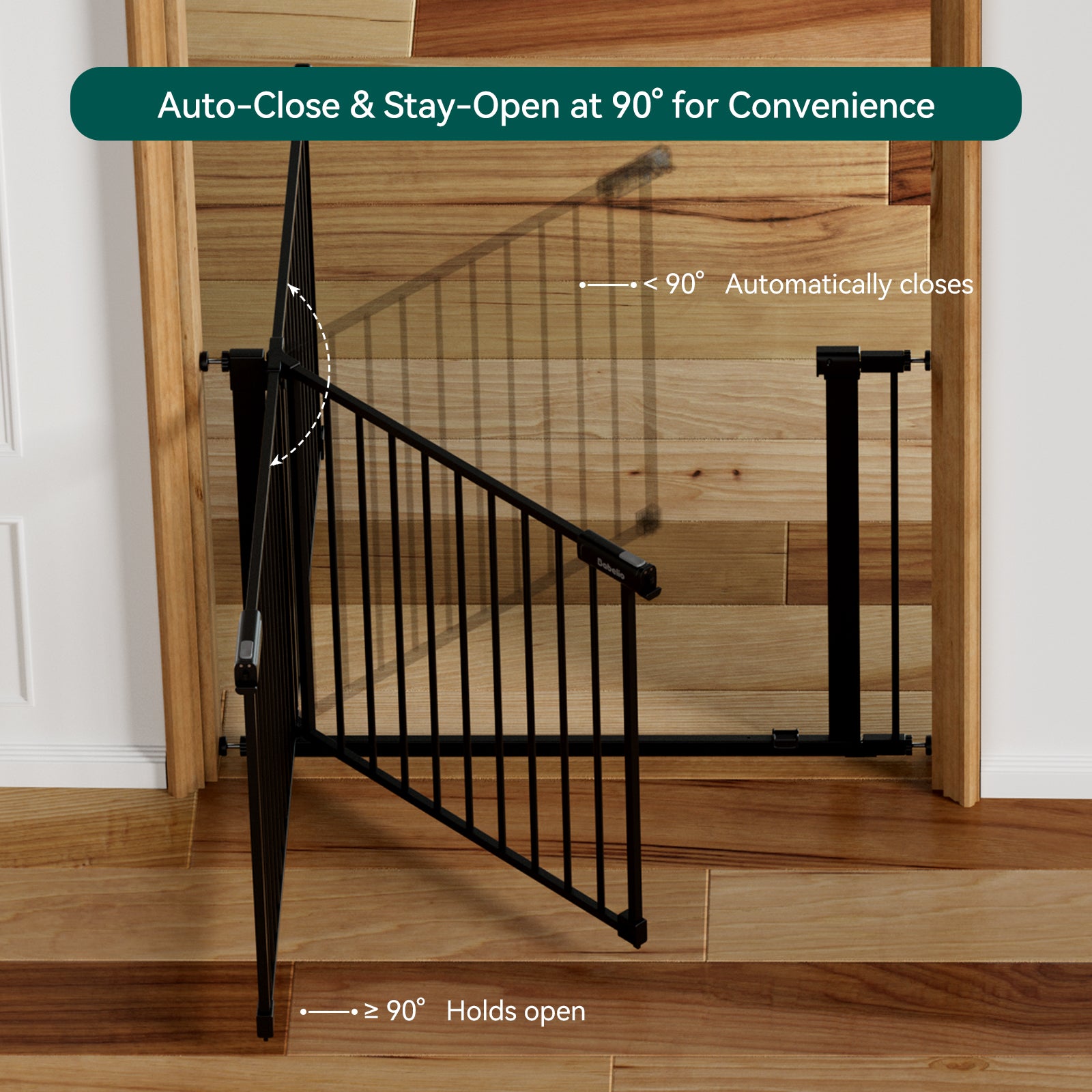 Black metal baby gate with text indicating auto-close and stay-open features in a home setting.#Color_Black