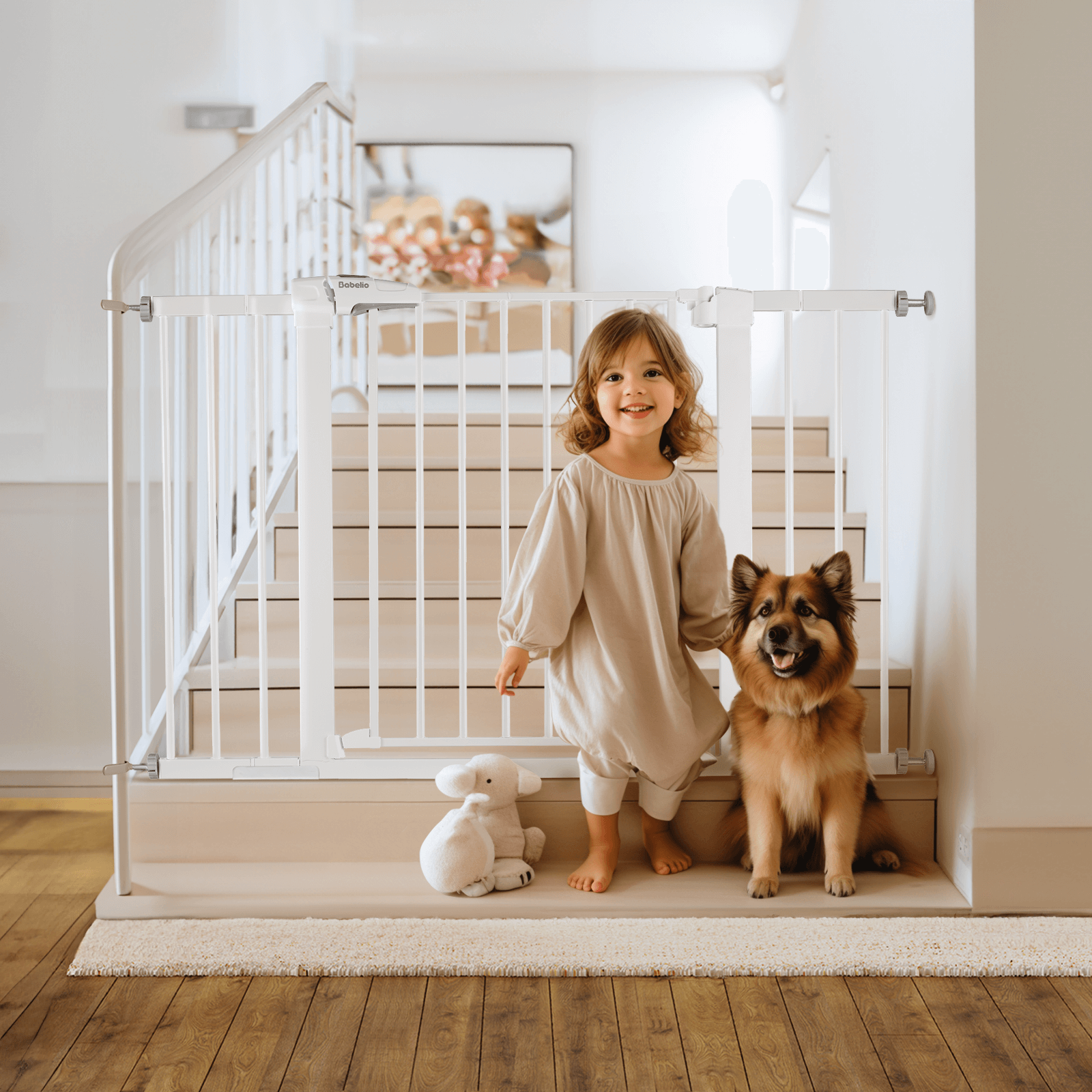 A child standing next to a white expandable baby gate that is pressure-mounteded and has a metal frame. There is a dog beside the child and a toy on the floor.