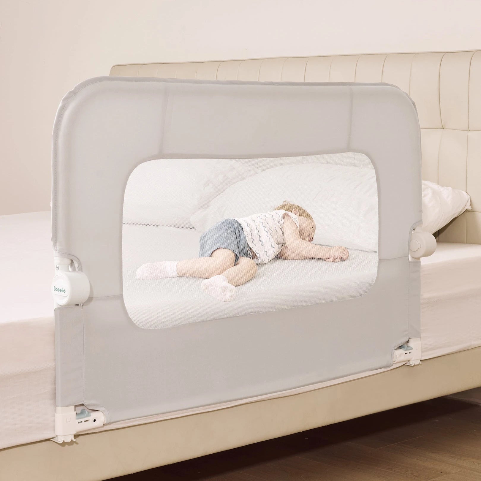 Babelio baby safety gate installed on a bedroom bed with a toddler sleeping safely inside.