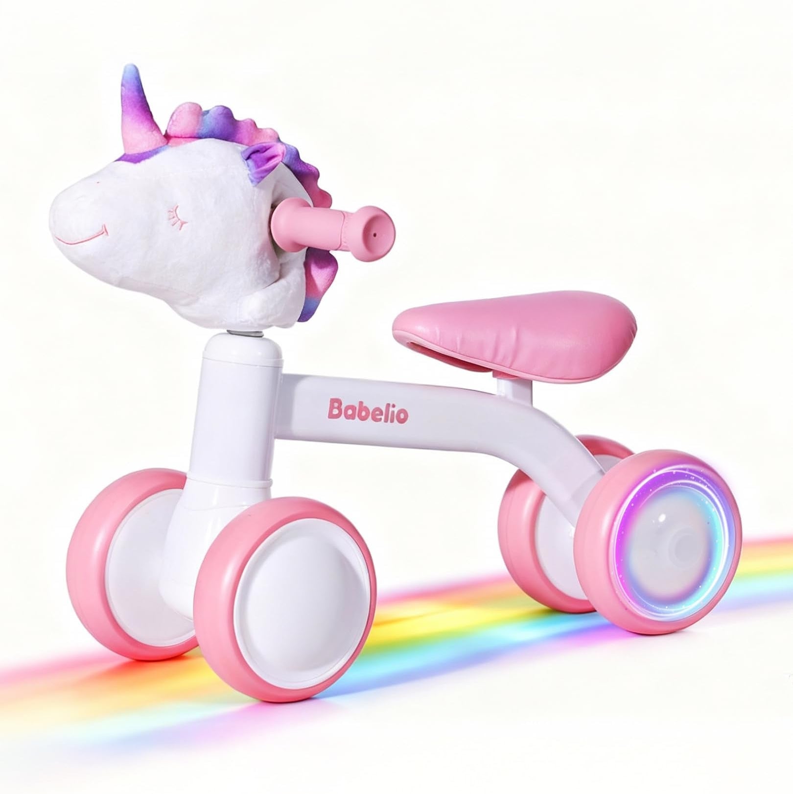 Balance bike for 1–3 year old girls, pink and white design with unicorn head and glowing wheels, outdoor toddler riding toy from the Magic Ride series by Babelio.