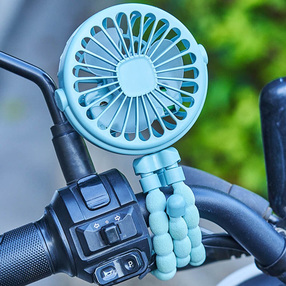 Babelio portable mini fan with bendable tripod legs attached to stroller handlebar outdoors