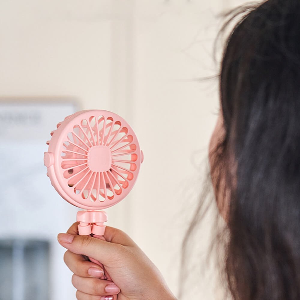 Babelio portable pink stroller fan with flexible tripod, held indoors