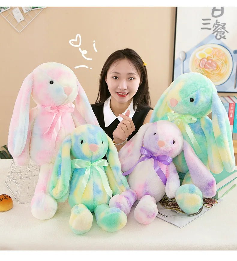Young woman with colorful plush bunny toys in a cozy room, Babelio baby gift setting