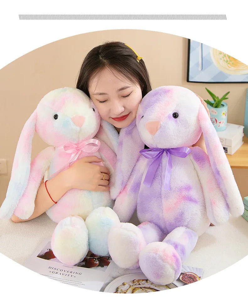 Babelio plush bunny toys with pastel colors and bows in a cozy bedroom setting