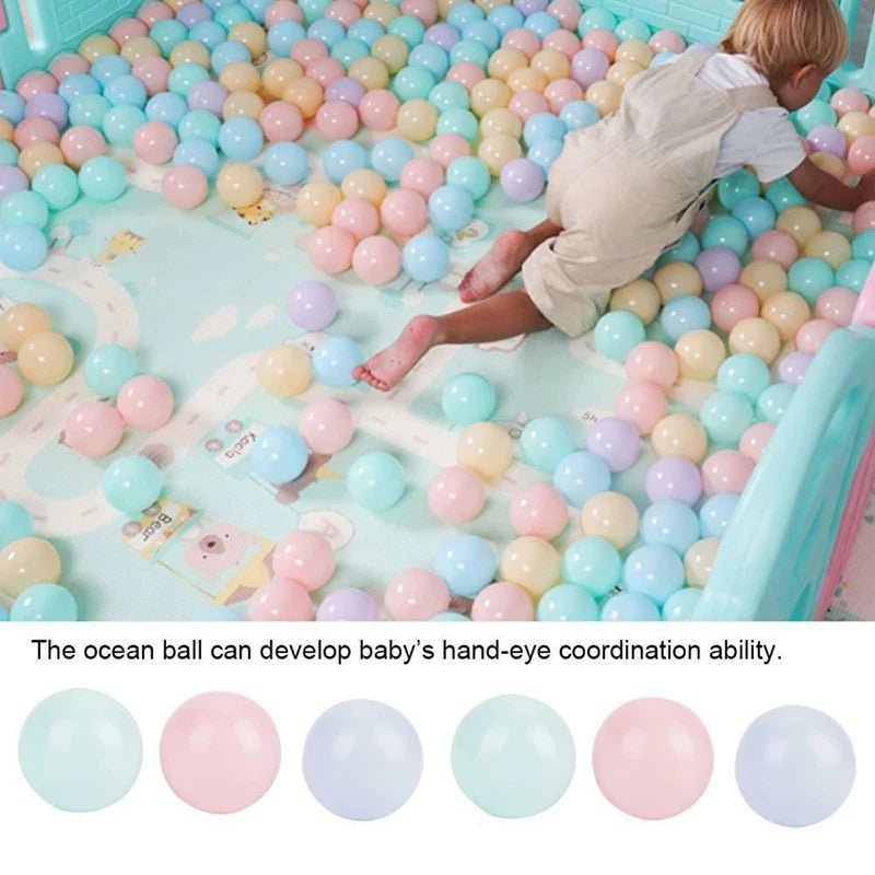 Babelio baby in a playpen with pastel ocean balls, nursery setting, safe play area