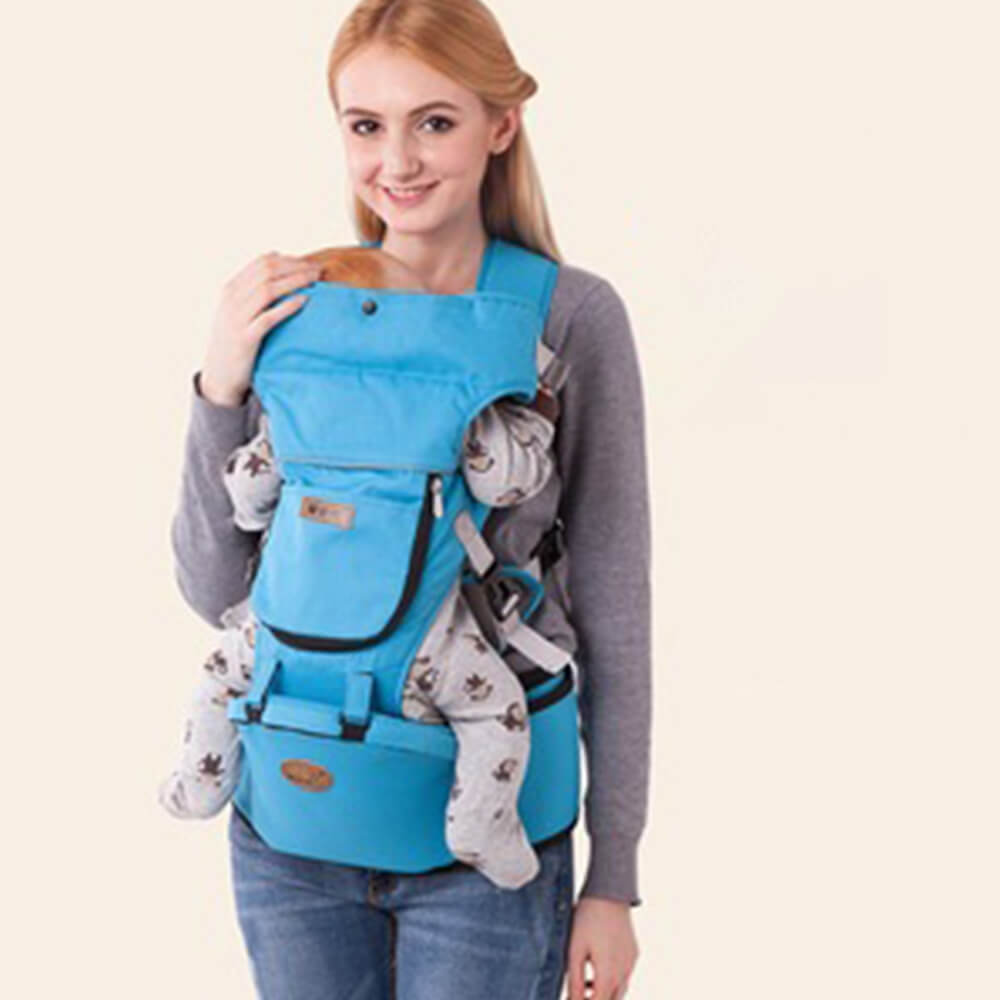 Babelio blue ergonomic baby carrier with hip seat worn by woman, baby facing inward