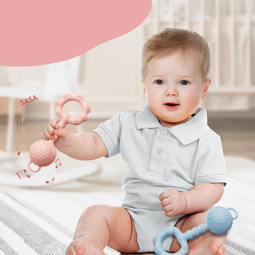 Babelio baby in nursery holding silicone teething rattle, soothing gum massager toy set