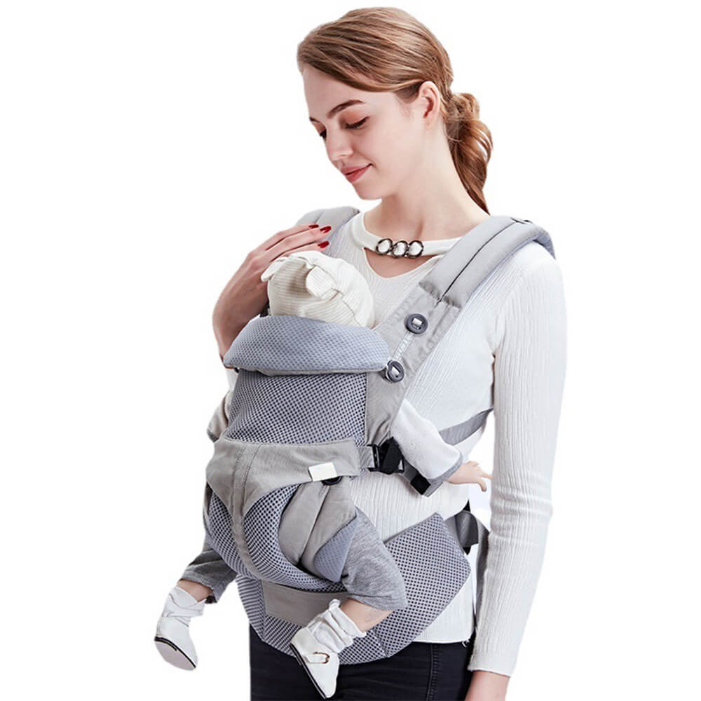 Woman using a Babelio ergonomic baby carrier with infant in a neutral indoor setting