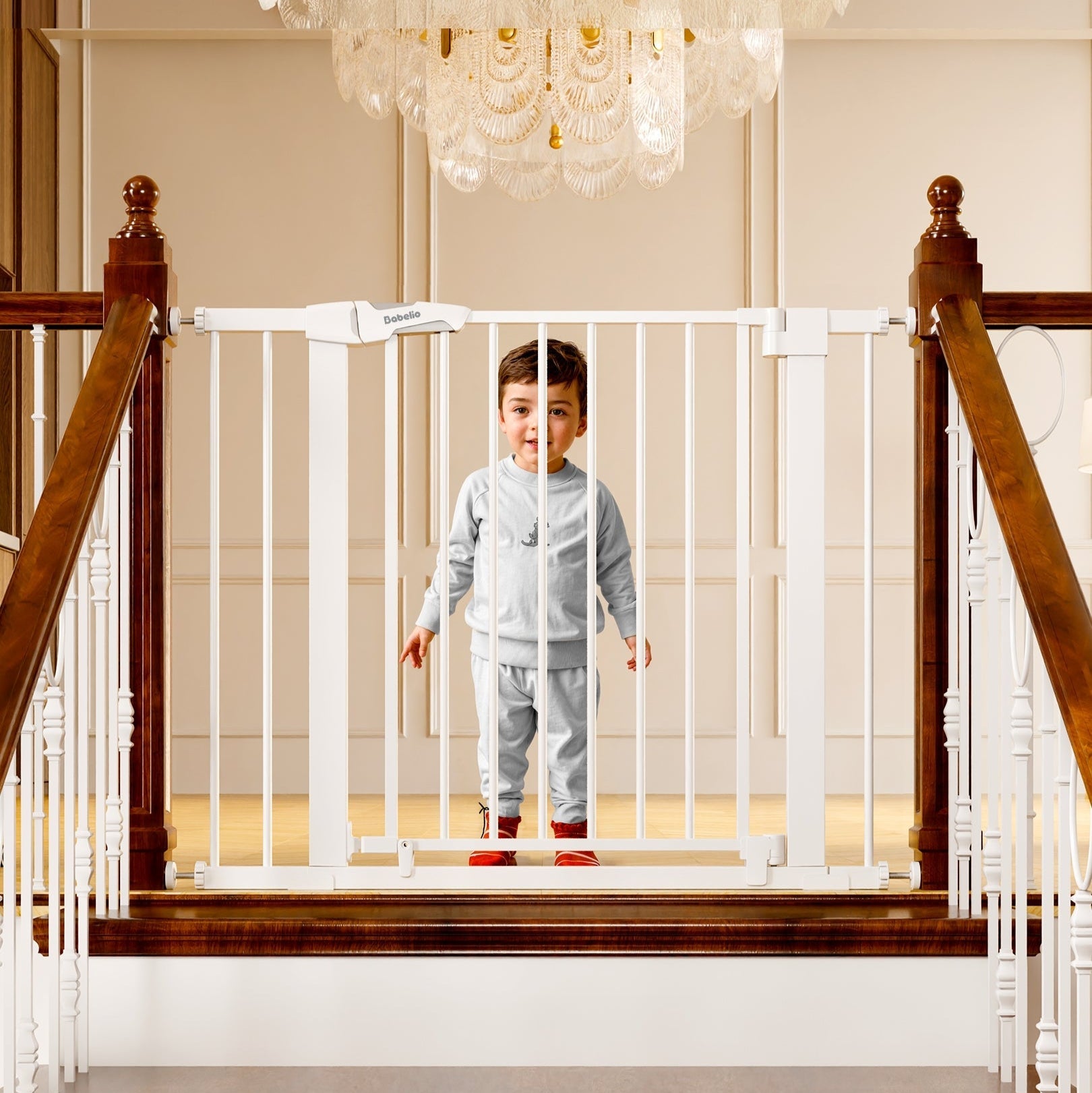 Babelio baby safety gate installed on staircase with toddler in bright, elegant hallway