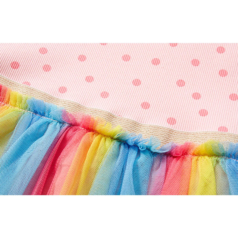 Babelio rainbow tulle baby dress detail with pink polka dot fabric, nursery setting